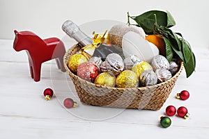 Swedish Christmas gift basket with sweets, fruits, and champagne