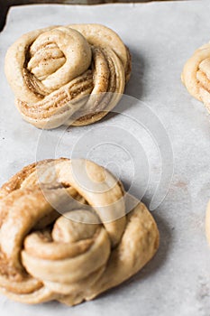 Swedish cinnamon buns dough on a parchment lined baking pan