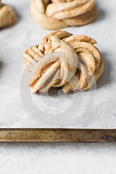 Swedish cinnamon buns dough on a parchment lined baking pan