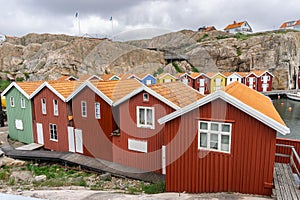 Swedish colorful cottages in the end of the bay on the island