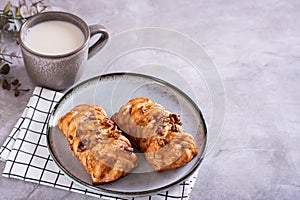 Swedish fika time with fresh cinnamon buns and a cup of latte on the table