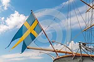 Swedish flag on the back of an old sailing ship