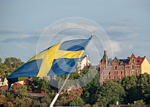 Swedish flag with SÃ¶dermalm in the background