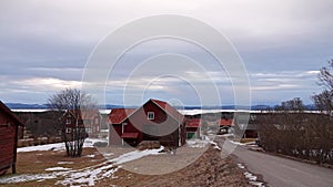 Swedish houses on shore of Frozen lake Orsa in Sweden photo