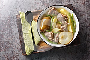 Swedish Lamb stew with fresh pears, potatoes, green beans close-up in a bowl. horizontal top view