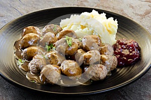 Swedish Meatballs with Lingonberry on Black Plate over Slate photo