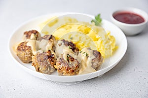 Swedish noisettes (fricandel) with mashed potatoes, Brune Sos creamy sauce and lingonberry (cranberry) sauce.