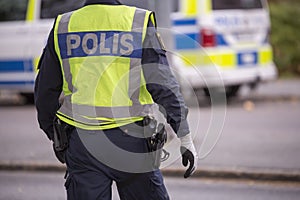 Swedish Police Officer with Reflective Vest and gun photo