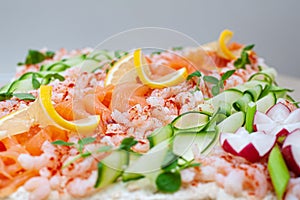 Swedish sandwich like cake or sandwich torte is a dish with seafood ingredients like salmon, shrimps and prawns photo