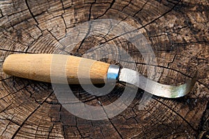 Swedish style  hooked wood carving knife on wood background , for wood carving and spoon making , hobby or pastime