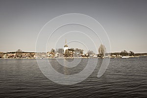 Swedish town Mariefred by lake Malaren, Sweden. Aged photo effect