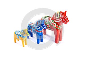 Swedish traditional souvenir Dala or Dalecarlian horses, different colors and sizes, isolated