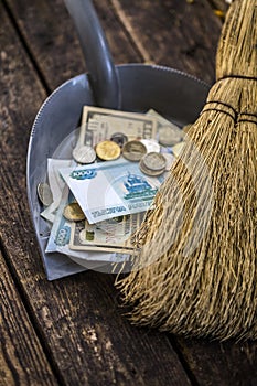 Sweep the money with a broom to collect in the scoop