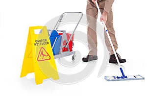 Sweeper cleaning floor with warning sign