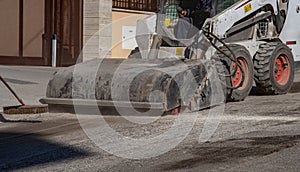 The sweeper sweeps, collects and dumps dirt photo