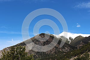 Sweeping landscape view of the summit of Mount Princeton, peaks covered in snow, in May in Nathrop, Colorado photo