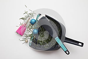 Sweeping up pine needles and broken decorations after Christmas holiday
