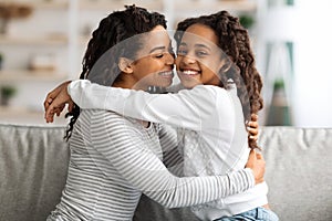 Sweet african american girl spending time with her mother