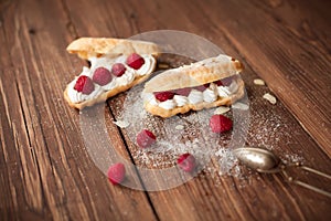 Sweet afters with fresh raspberries on wood table photo