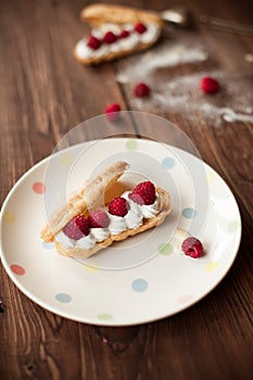 Sweet afters with fresh raspberries on wood table photo