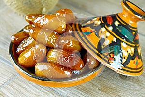 Sweet algerian dates fruits on arabic traditional pottery plate