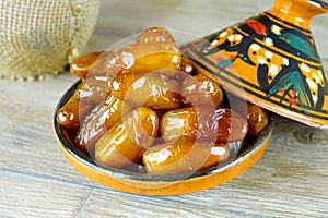 Sweet algerian dates fruits on arabic traditional pottery plate