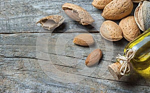 Sweet Almond oil in glass of bottle. Almonds nuts and oil concept