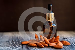 Sweet almond oil in glass jar and kernels