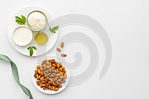 Sweet almond oil and milk with nuts seeds. Healthy food and cosmetic background