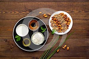 Sweet almond oil and milk with nuts seeds. Healthy food and cosmetic background