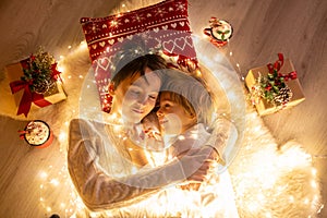 Sweet amazing cute children, boy brothers, hugging at home in front of the fireplace on Christmas