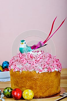 Sweet and appetizing cupcake with pink sprinkling on the table