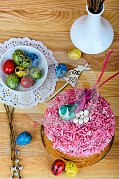 Sweet and appetizing cupcake with pink sprinkling on the table