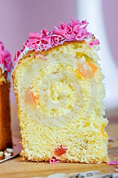 Sweet and appetizing cupcake with pink sprinkling on the table