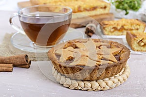 Sweet apricot cake - tartlet of pastry filled with jam and a cup of tea