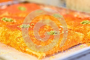 Sweet arab dessert kunefe, kunafa, kadayif in the market.