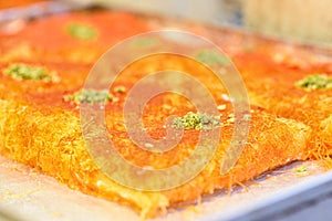 Sweet arab dessert kunefe, kunafa, kadayif in the market. photo