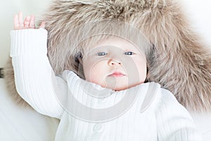 Sweet baby in a big fur hat