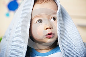 Sweet baby boy with blue blanket.