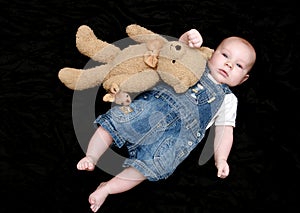 Sweet baby boy with cuddly toy photo