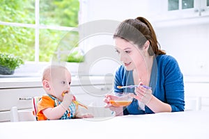 Sweet baby boy eating his first solid food