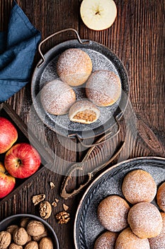 Sweet baked buns with apple and walnut filling, sprinkled with powdered sugar