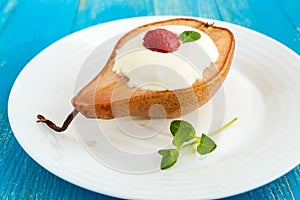 Sweet Baked pear with cream, raspberry syrup, fresh raspberries and mint leaves.