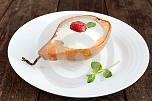 Sweet Baked pear with cream, raspberry syrup, fresh raspberries and mint leaves.