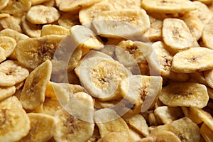 Sweet banana slices as background. Dried fruit