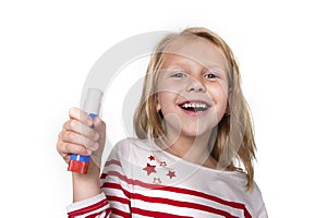 Sweet beautiful female child holding glue stick school supplies concept