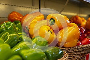 Sweet bell peppers of different colors on a shelf in a store. Close-up. Healthy nutrition and vitamins