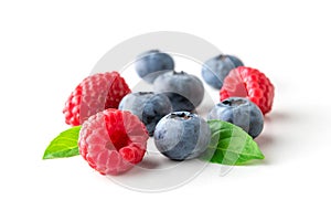 Sweet berries mix isolated on white background. Ripe raspberry and blueberry