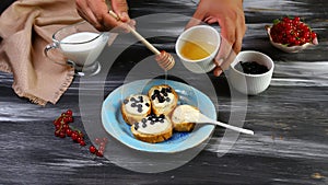 Sweet berry crostini sandwiches with cream cheese ricotta and honey by chef hand. Top view with copy space