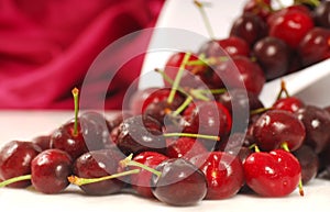 Sweet bing cherries flowing out of a colander